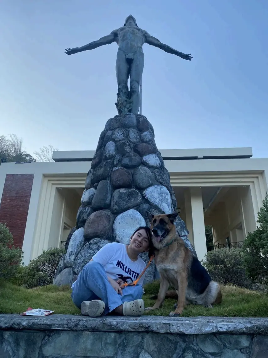 Atty. Matiling with Pia, their German Shepherd, at the UP Oblation